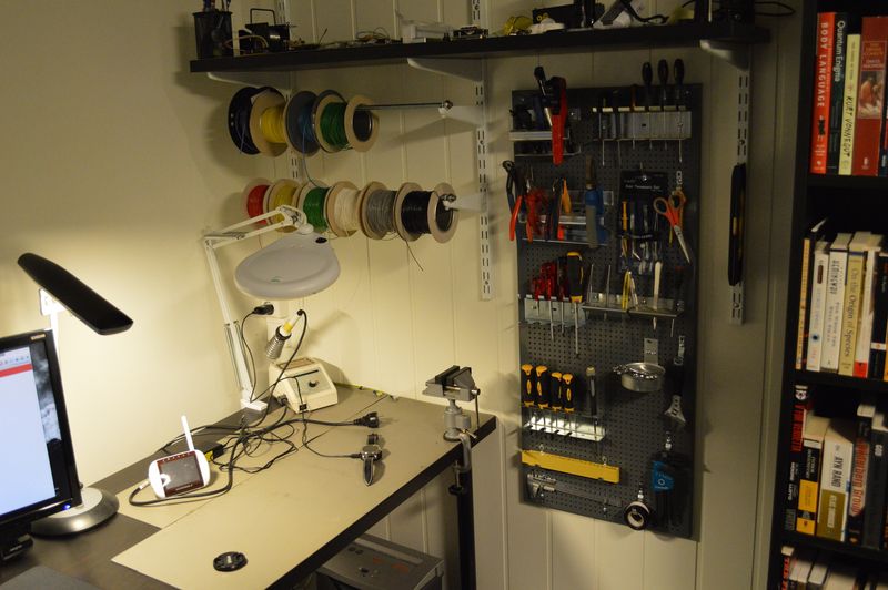 Electronics work area with soldering iron, wire spools and tools