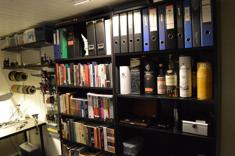 Bookshelves with books, documents, whisky and cigar accessories