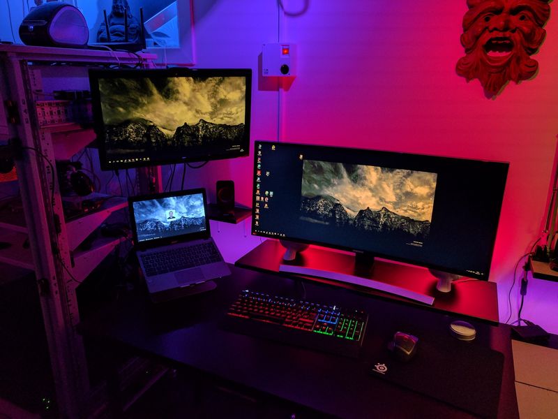 Computer desk with laptop, ultrawide and regular monitor, with RGB lighting