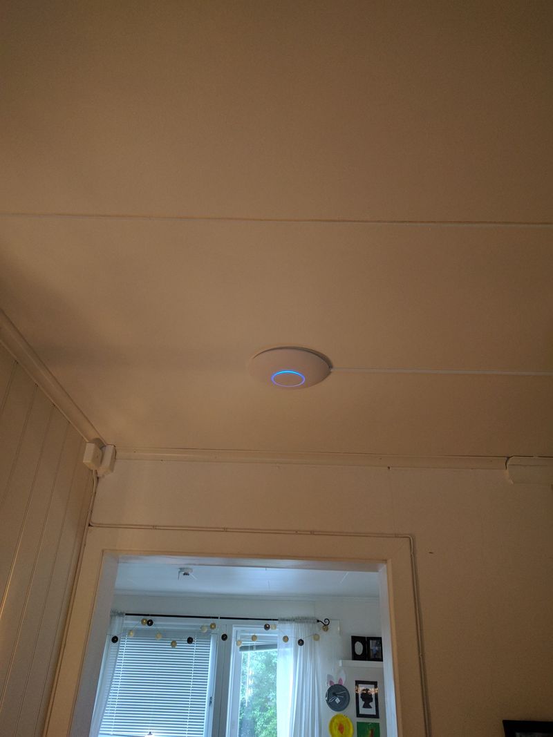 Unifi WiFi access point mounted in ceiling