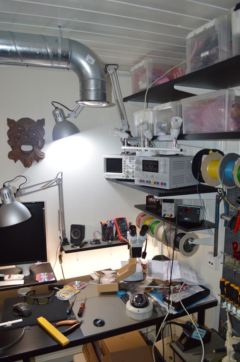 Spiral duct with bend, suspended above electronics workbench