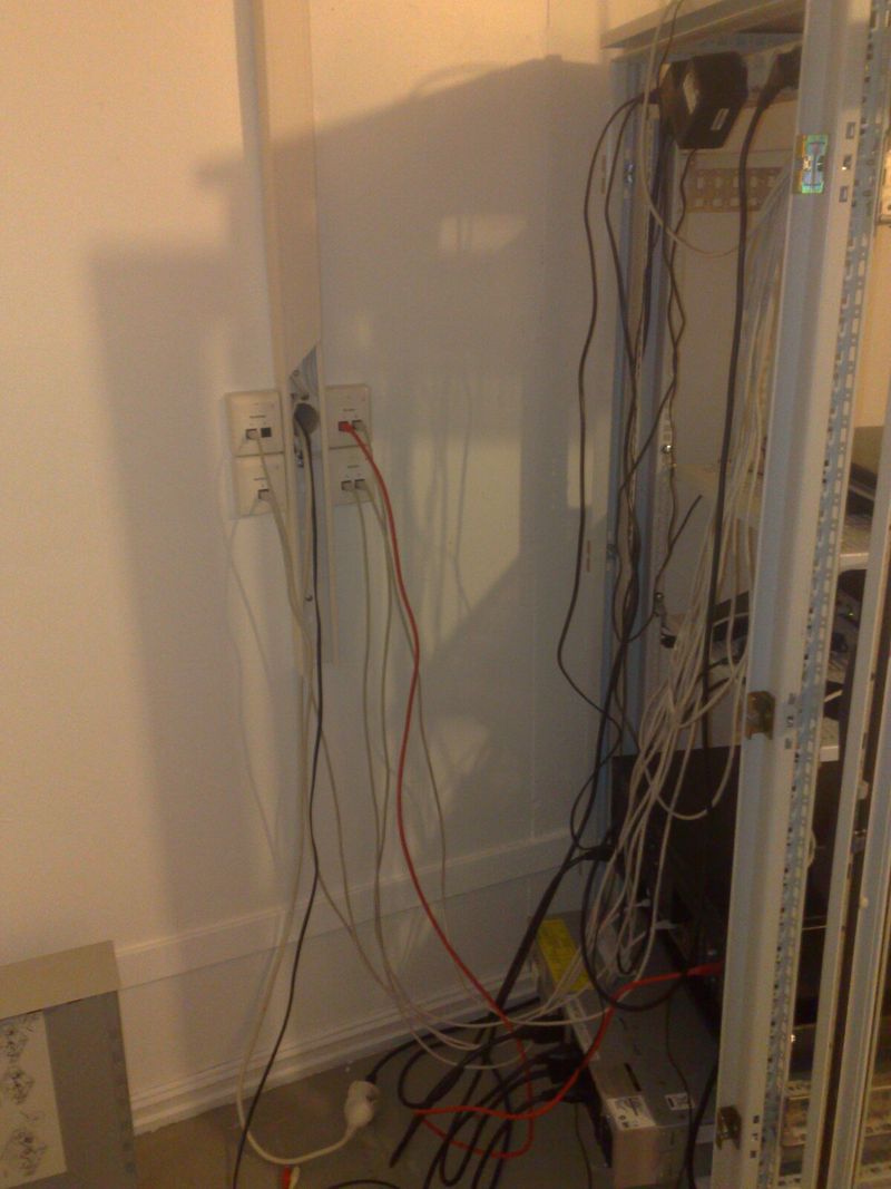 Backside of server rack, with power and network cables