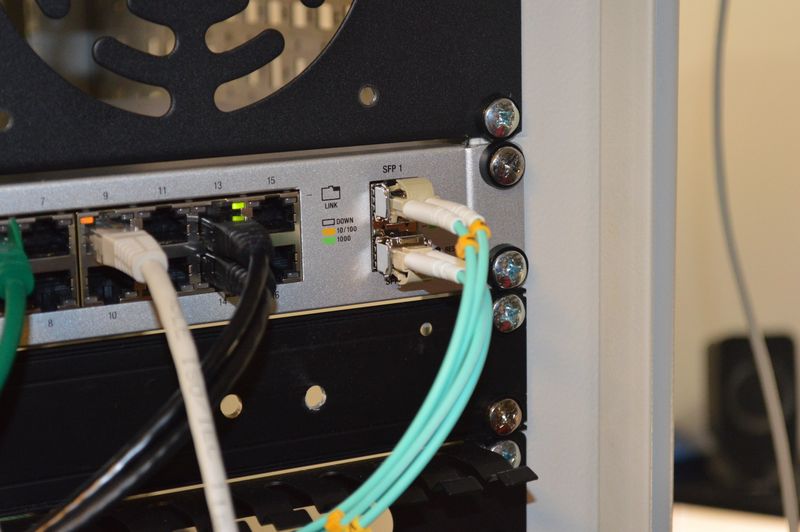 Network and fiber connected to Unifi switch mounted in rack