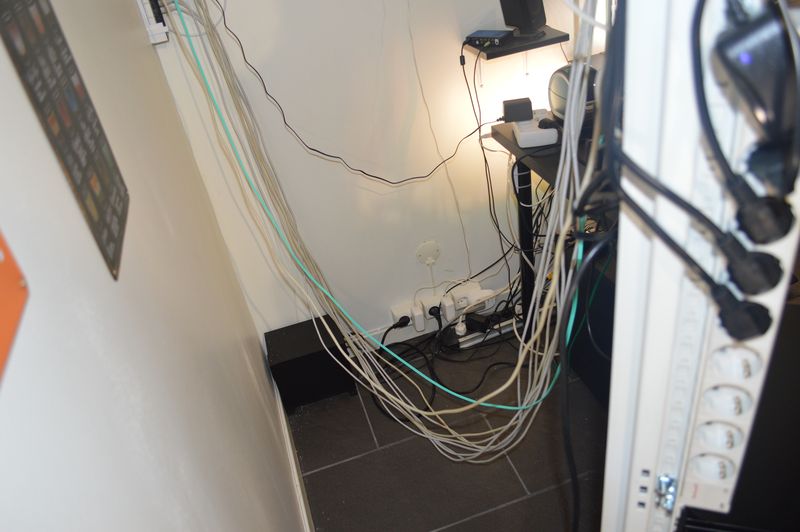 Network and fiber cables going from server rack to patch panel