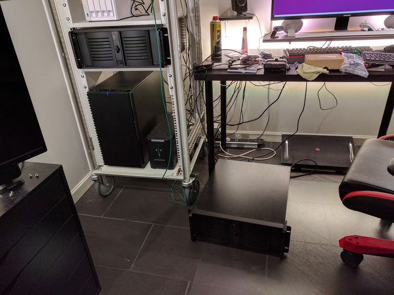 Server lying on the floor, next to computer rack