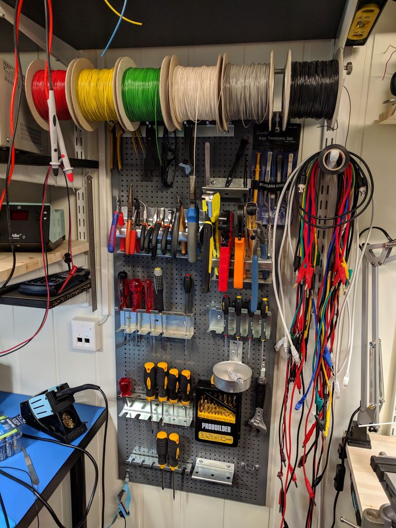 Peg-board with tools, test leads, and wire spools