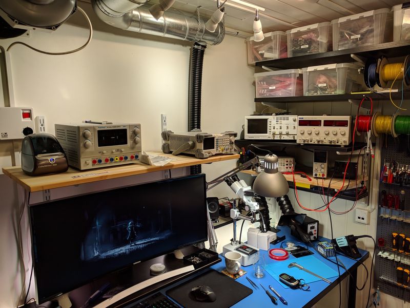 Electronics lab, with instruments, power supplies, storage, and computer with ultrawide monitor