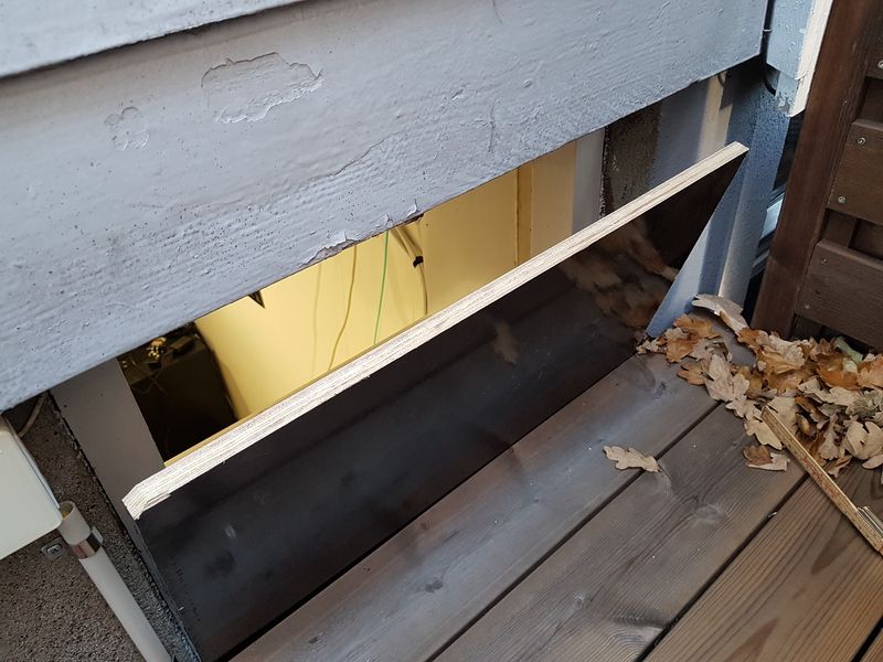 Film-coated plywood placed in basement window opening