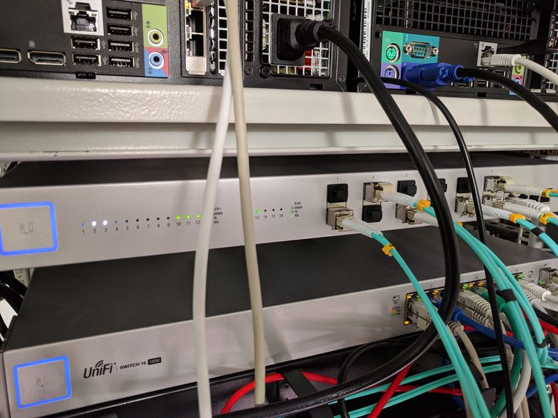 Ubiquiti UniFi 16XG 10 Gbit and 16 POE-150W switches, with fibers and Ethernet connected