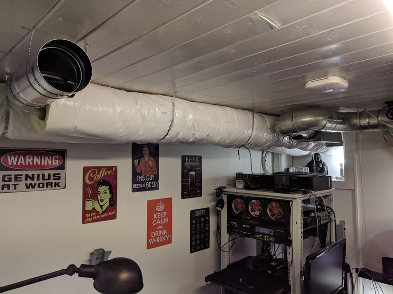 Insulated ducts suspended from the ceiling and fresh air intake