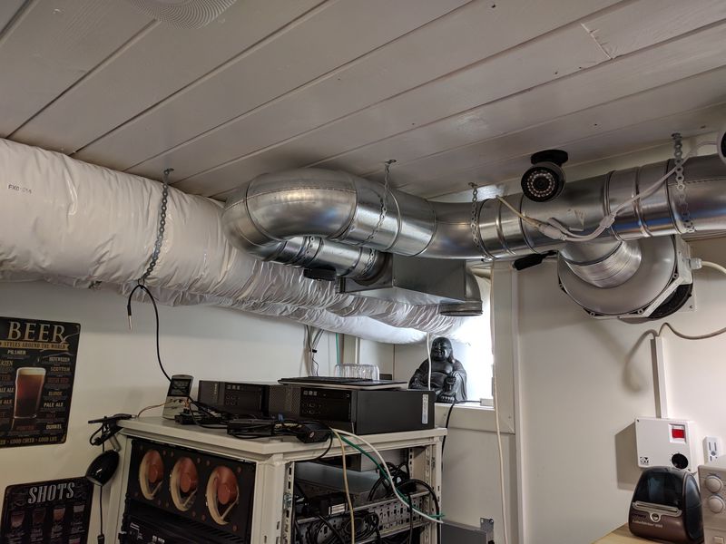 Ductwork in the ceiling for ventilation exhaust intake above homelab rack