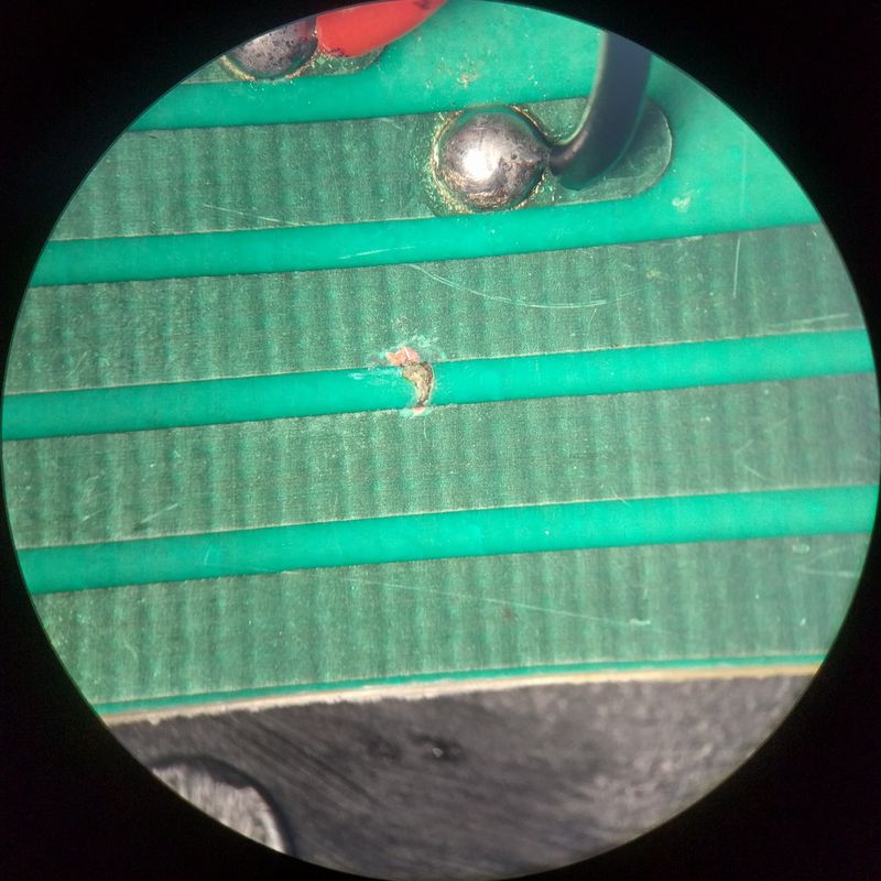 Mark between copper lanes on PCB, through microscope