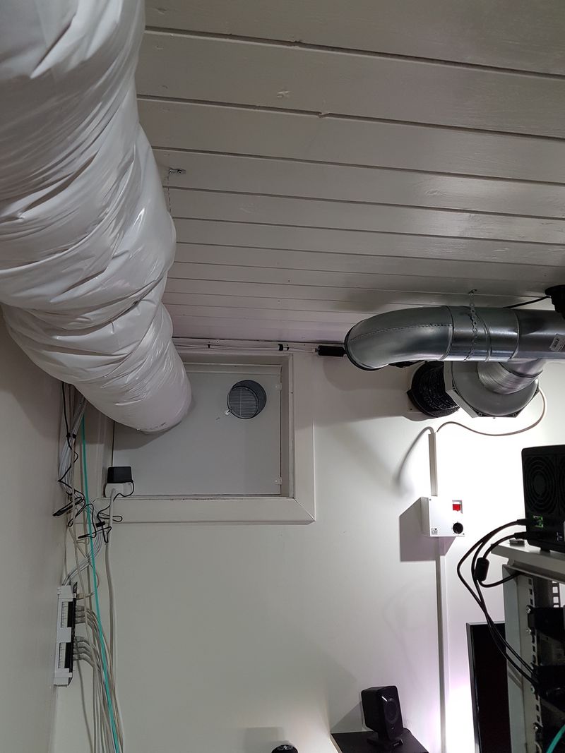 Insulated duct suspended from ceiling, two unfinished ventilation ducts