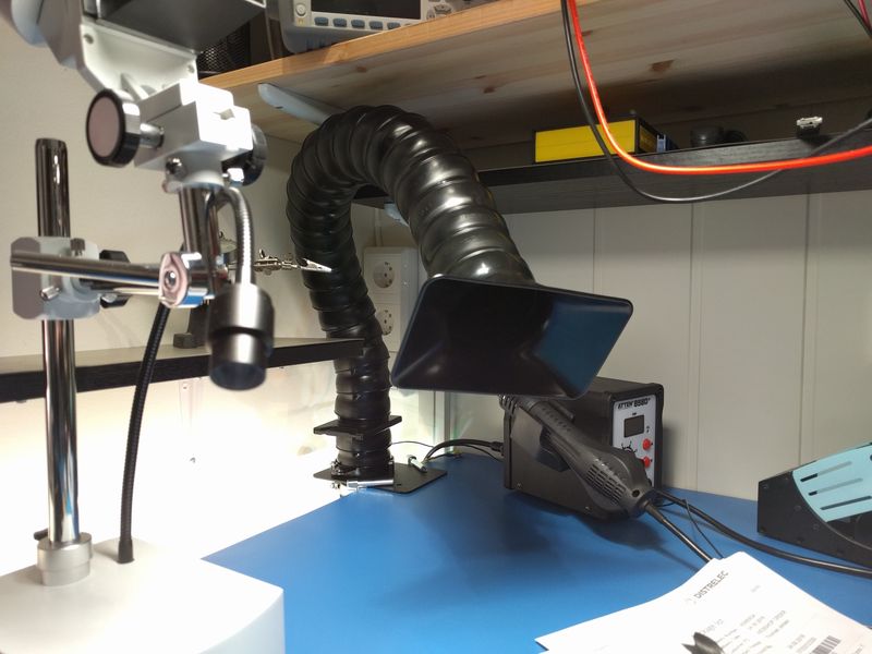 Fume extraction arm with hood, on electronics workbench