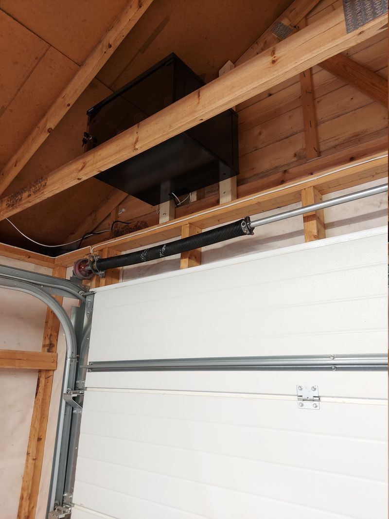 Rack cabinet mounted above garage door