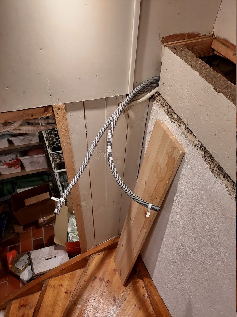 Loose conduits in basement stairwell