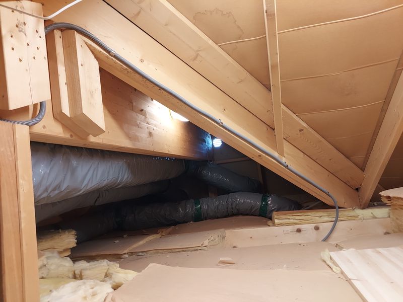 Flexible conduit mounted to rafter in attic