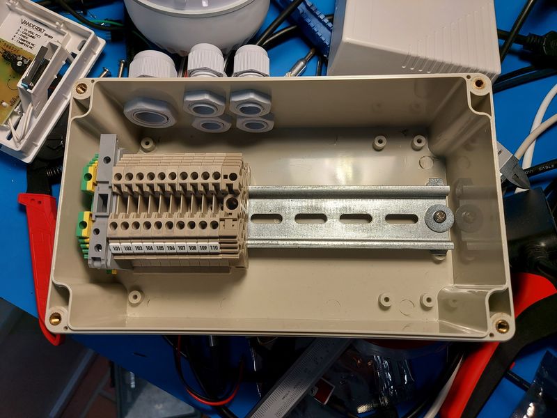 Small plastic enclosure — with DIN rail, terminal blocks, and cable glands