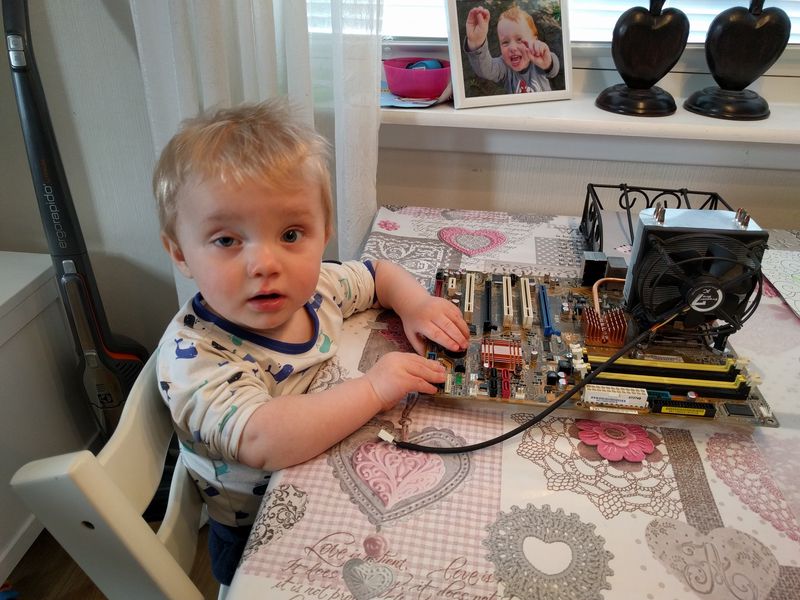 Adrian, playing with computer parts and motherboard in 2019